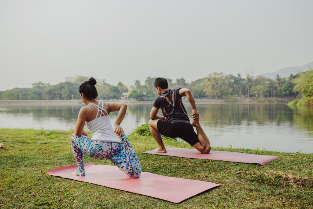 couple doing yoga with beautiful landscape