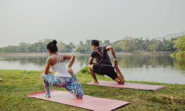 couple doing yoga with beautiful landscape
