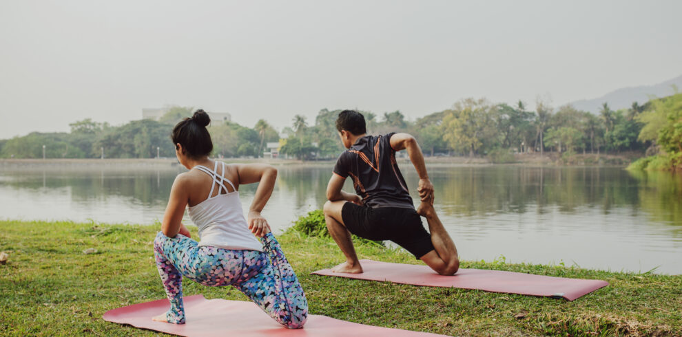 couple doing yoga with beautiful landscape